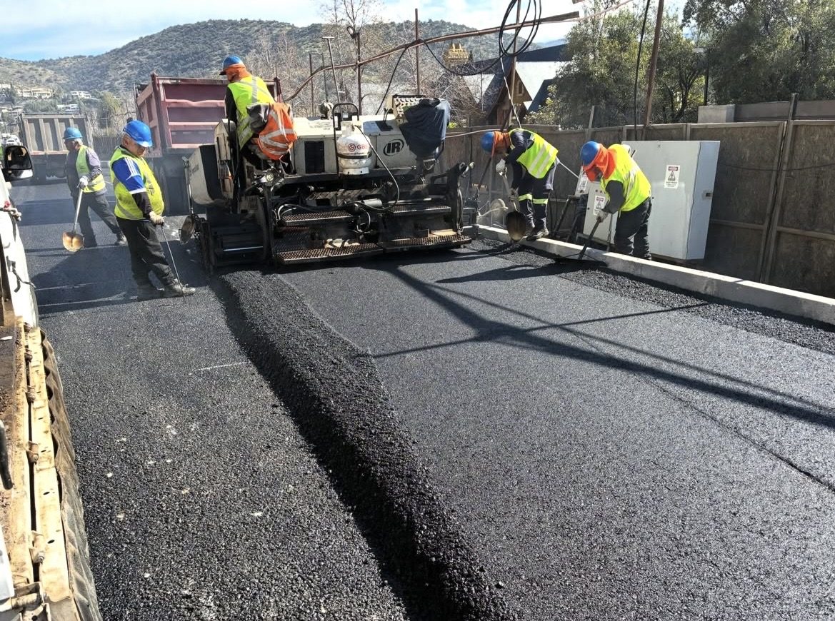 Cuadrilla extendiendo carpeta asfáltica con una pavimentadora